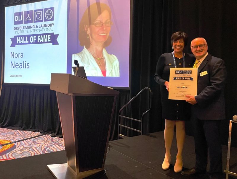 Dawn Hargrove-Avery accepting Nora Nealis’s DLI Hall of Fame recognition on her behalf, beside the presenter